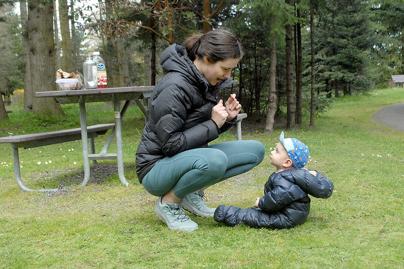 Anna Brady of Kingston shares a moment with her son, Owen, 9 months, after a picnic lunch at Robin Hill Farm County Park west of Sequim over the weekend. The lunch was a prelude to a family bike ride on the Olympic Discovery Trail. (Keith Thorpe/Peninsula Daily News)