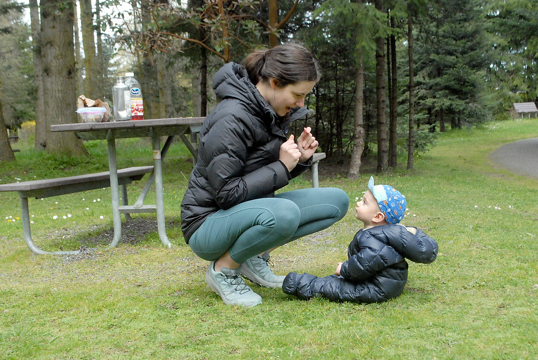 Anna Brady of Kingston shares a moment with her son, Owen, 9 months, after a picnic lunch at Robin Hill Farm County Park west of Sequim over the weekend. The lunch was a prelude to a family bike ride on the Olympic Discovery Trail. (Keith Thorpe/Peninsula Daily News)