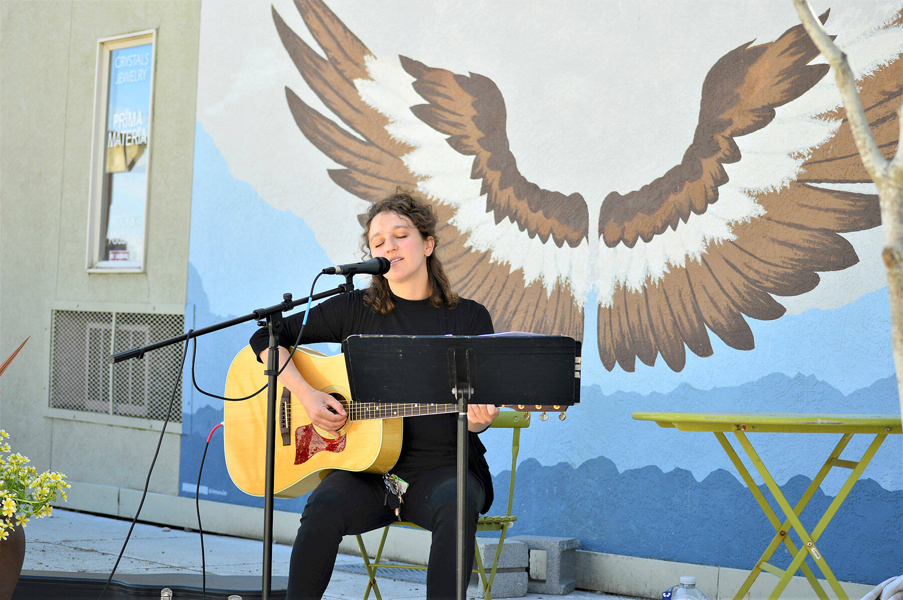 Phina Pipia of Port Townsend, pictured in spring 2021, is one of the multi-instrumentalists returning to the Buskers on the Block series of free performances this month and next. Tyler Street Plaza in downtown Port Townsend, with Nora Kingsley’s wings mural, is the setting. (Diane Urbani de la Paz/Peninsula Daily News)