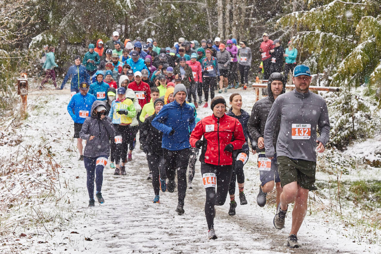 Runners start the 12K portion of the annual Olympic Adventure Trail run along Kelly Ridge west of Port Angeles this weekend. Heavy snow, sleep, hail and rain greeted runners during this year's race. (Matt Sagen/Cascadia Films)