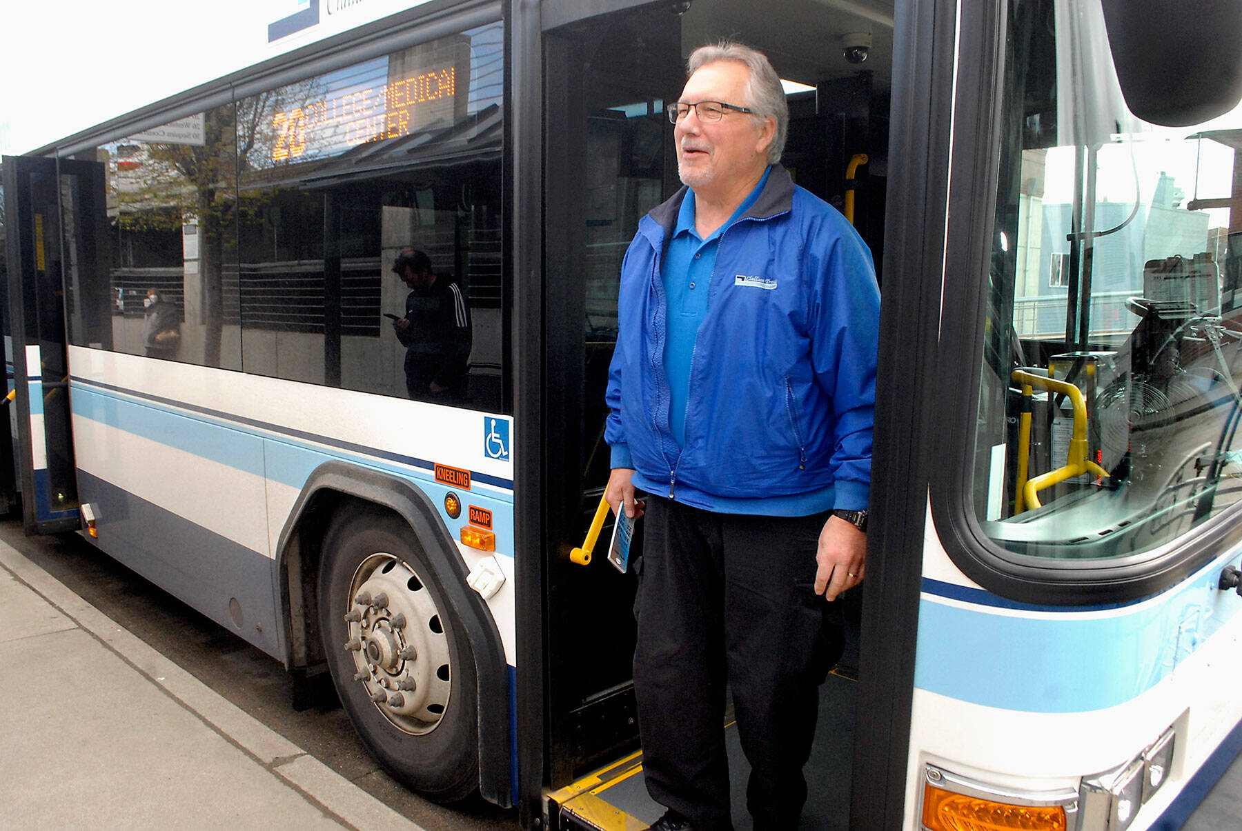 Clallam Transit driver Joe Sutton steps off his bus without a mask after arriving at The Gateway transit center in downtown Port Angeles on Tuesday. (Keith Thorpe/Peninsula Daily News)