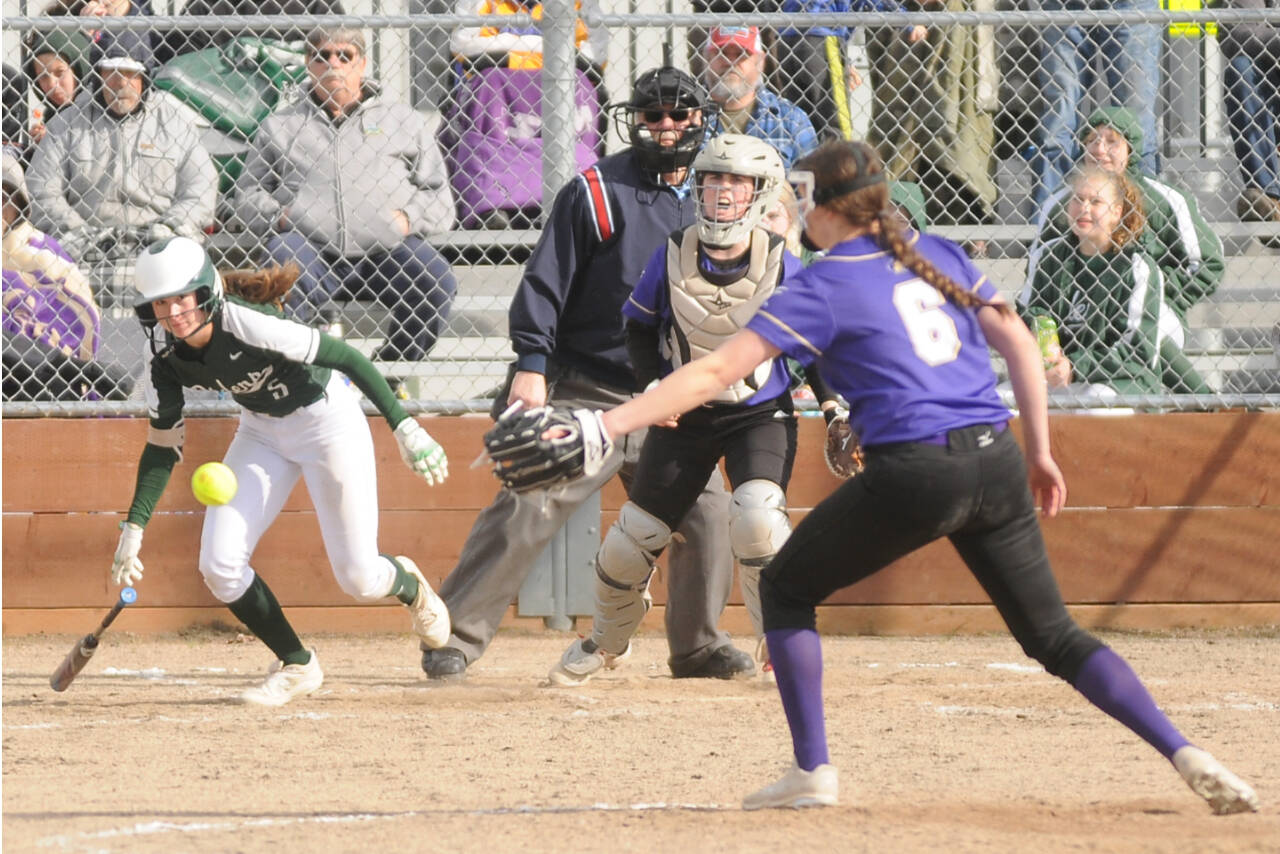 Michael Dashiell/Olympic Peninsula News Group
Port Angeles' Zoe Smith hits the ball past Sequim pitcher Angel Wagner as Wolves' catcher Christy Grubb is also in on the play.