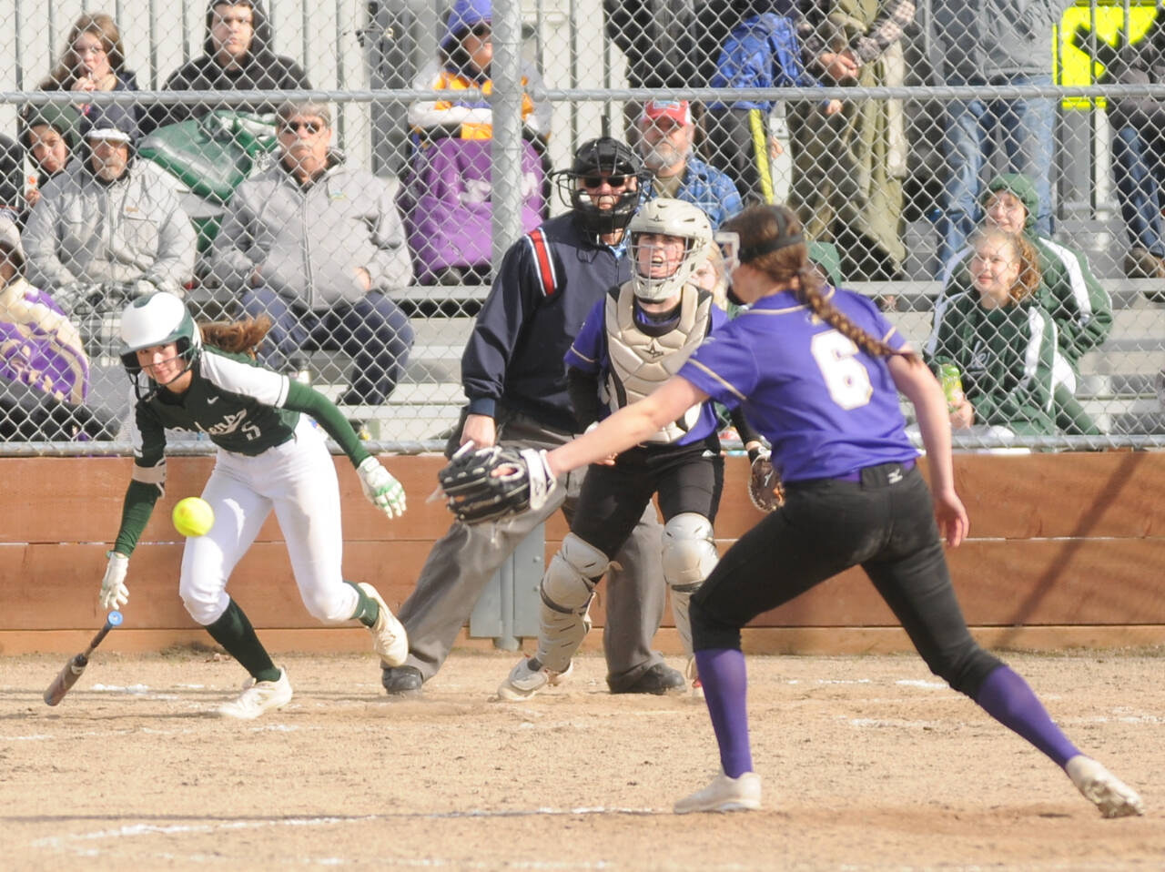 Port Angeles Zoe Smith hits the ball past Sequim pitcher Angel Wagner as Wolves catcher Christy Grubb is also in on the play. (Michael Dashiell/Olympic Peninsula News Group)