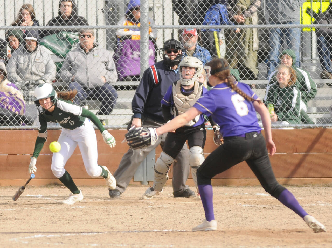 Port Angeles’ Zoe Smith hits the ball past Sequim pitcher Angel Wagner as Wolves’ catcher Christy Grubb is also in on the play. (Michael Dashiell/Olympic Peninsula News Group)