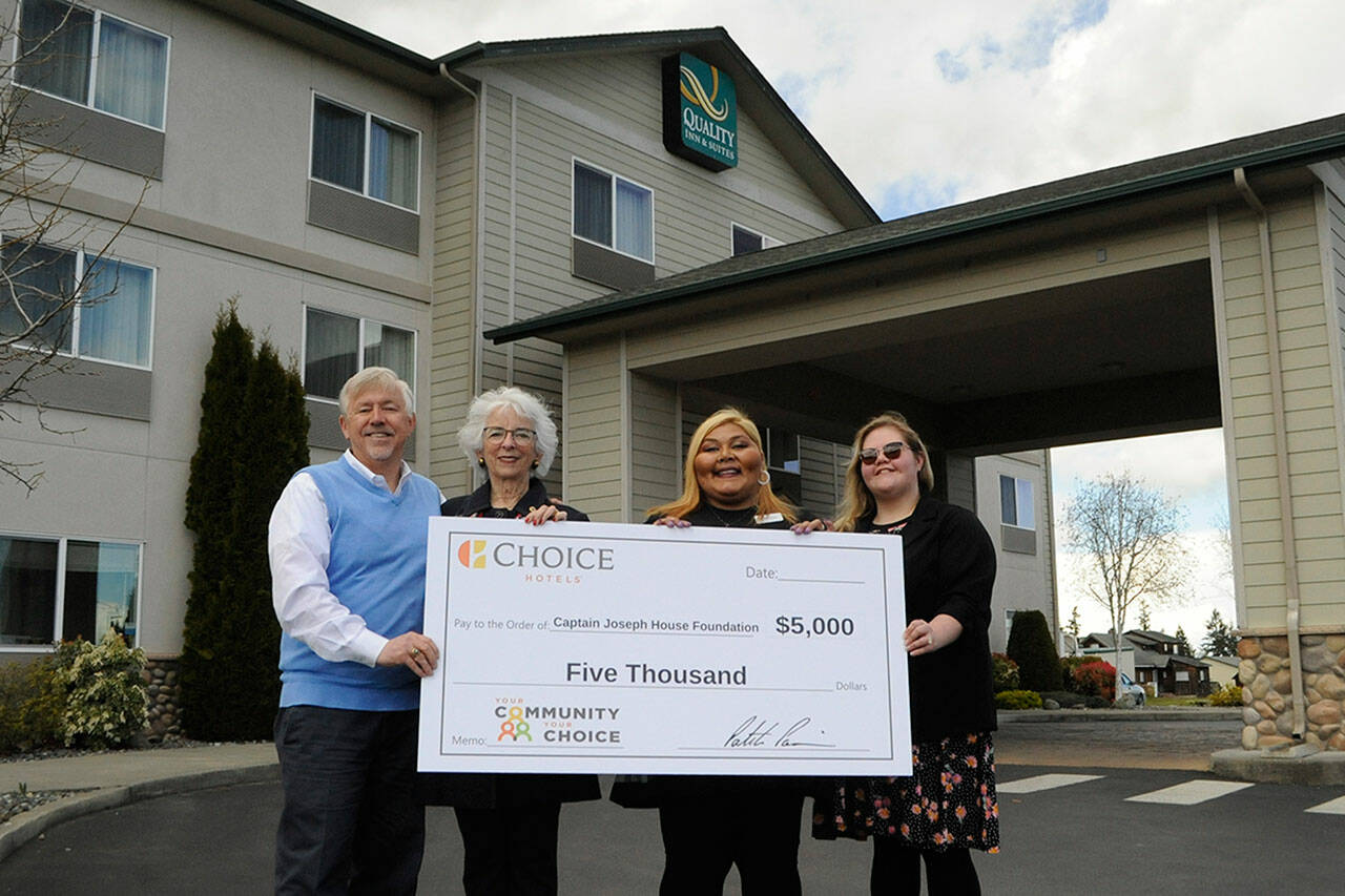 Bret Wirta, owner of the Quality Inn and Suites in Sequim, on left, with General Manager Yolanda Pompa and Kaittlyn Reese, assistant general manager, present Betsy Reed Schultz, executive director of the Captain Joseph House Foundation, second from left, $5,000 to help bring families to the Port Angeles home for respite and support. Pompa applied for the grant through the hotel’s parent franchise Choice Hotels. (Matthew Nash/Olympic Peninsula News Group)