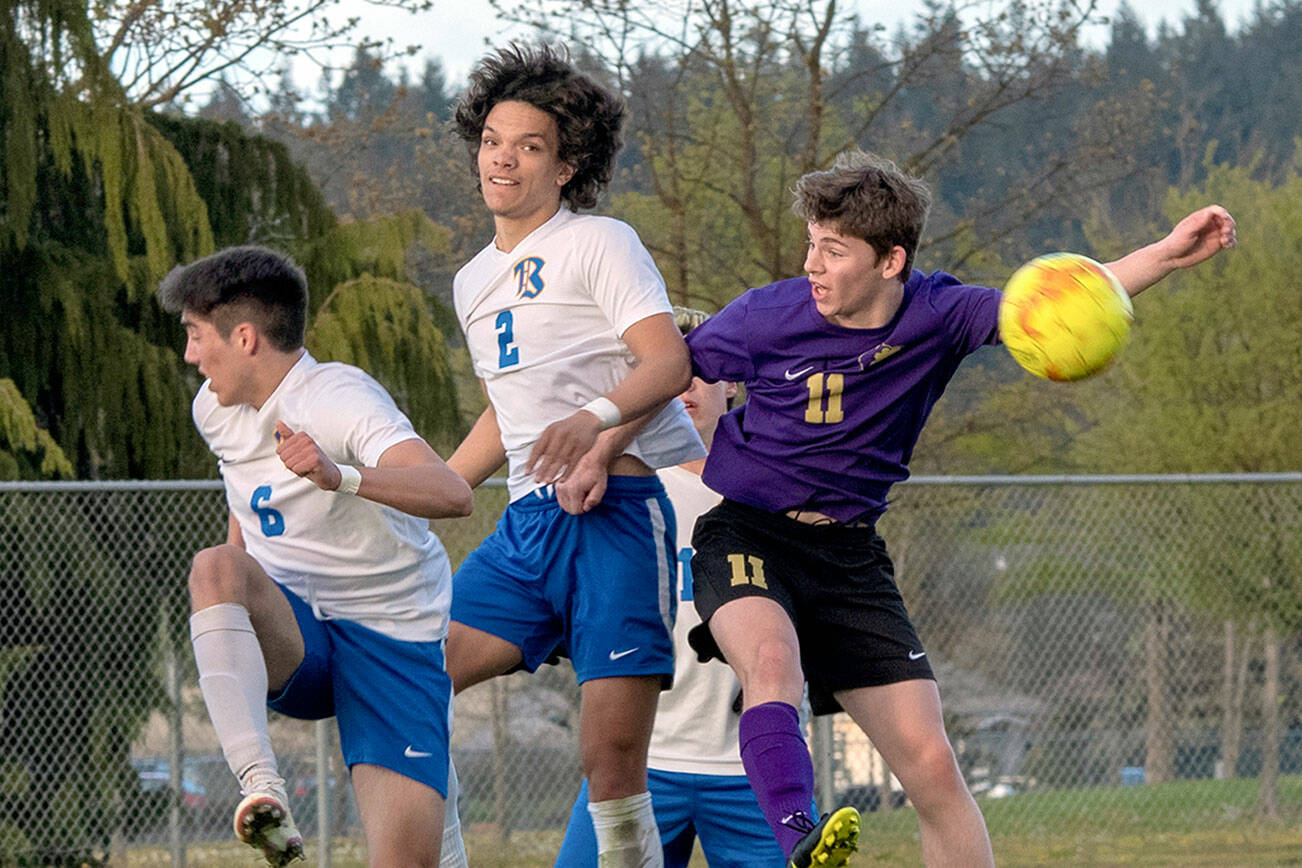 Emily Matthiessen/Olympic Peninsula News Group
As Knights Aidan Harvey (2) and Diego Clemen (6) defend, Sequim's Ethan Knight goes up for a header in the Wolves' April 26 home league game against Bremerton. Bremerton won the match 3-1.