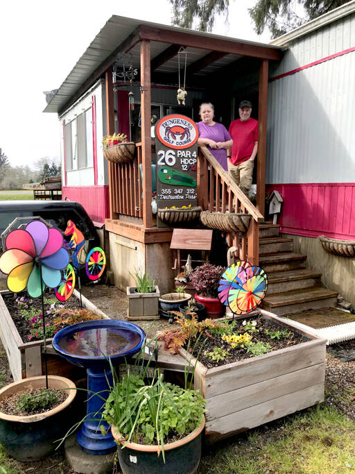 Dee, left, and Jerry Janssen moved to the Rain Forest Mobile Home Park in Forks three years ago after they were priced out of their rented mobile home in Sequim. The couple is now faced with trying to find another place to live where they can bring their two Labrador retrievers. (Paula Hunt/for Peninsula Daily News)