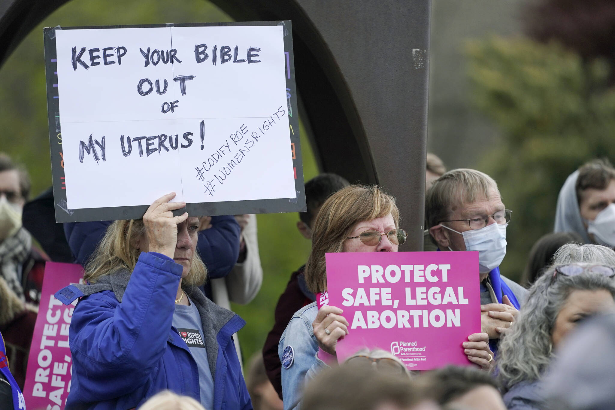 Ted S. Warren / The Associated Press
A person holds a sign that reads “Keep Your Bible out of My Uterus!” on Tuesday during a rally at a park in Seattle in support of abortion rights.