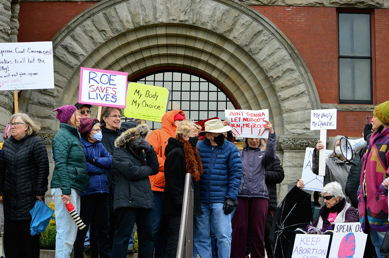 About 40 women and men waved signs and chanted “My body, my choice!” outside the Jefferson County Courthouse in Port Townsend on Tuesday evening. (Diane Urbani de la Paz/Peninsula Daily News)