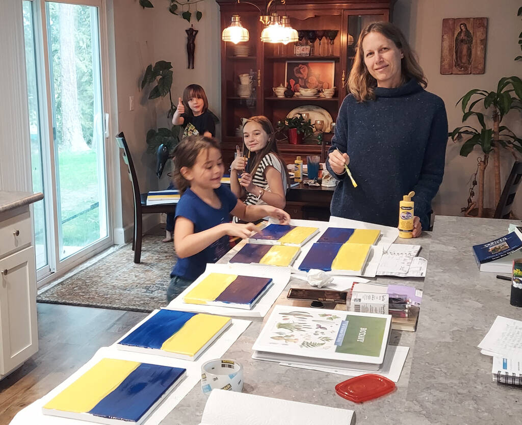 Kyle Johnson
Josephine Johnson, second from right, and family get to work on her artwork fundraiser to aid refugees from the Russian invasion of Ukraine.