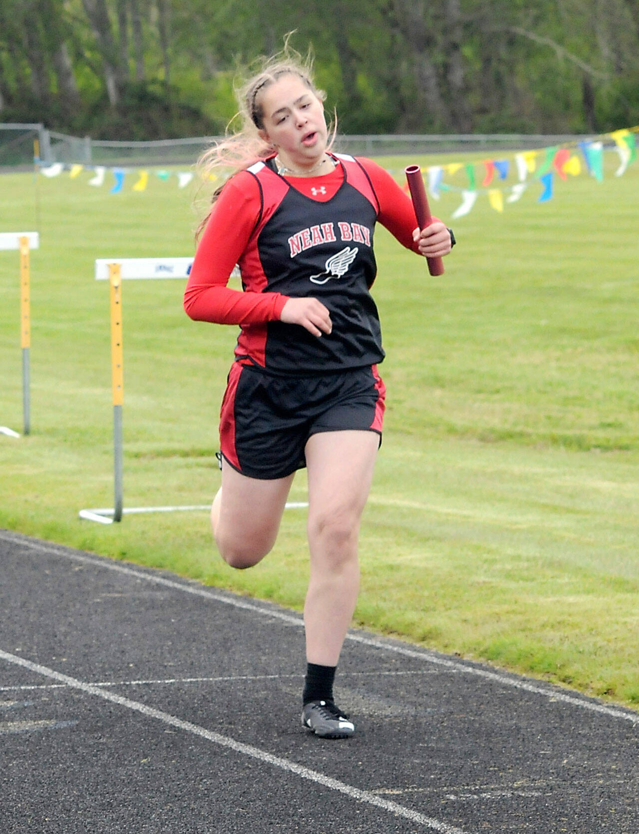 Keith Thorpe/Peninsula Daily News
Anchor Wiinuk Martin of Neah Bay crosses the finish line for her team to win the girls 4x200 meter relay on Friday at Crescent School in Joyce.