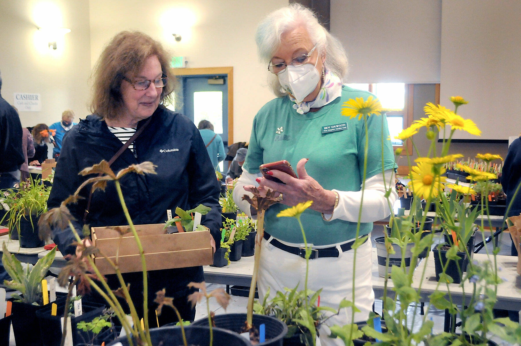 Peggy DeYoung of Port Angeles, left, talks about plants with Port Angeles Garden Club member Bev Dawson during the group’s annual plant sale on Saturday at the Port Angeles Senior Center. The sale featured perennials, annuals, succulents and vegetable starts and served as a fundraiser for garden club activities. (Keith Thorpe/Peninsula Daily News)