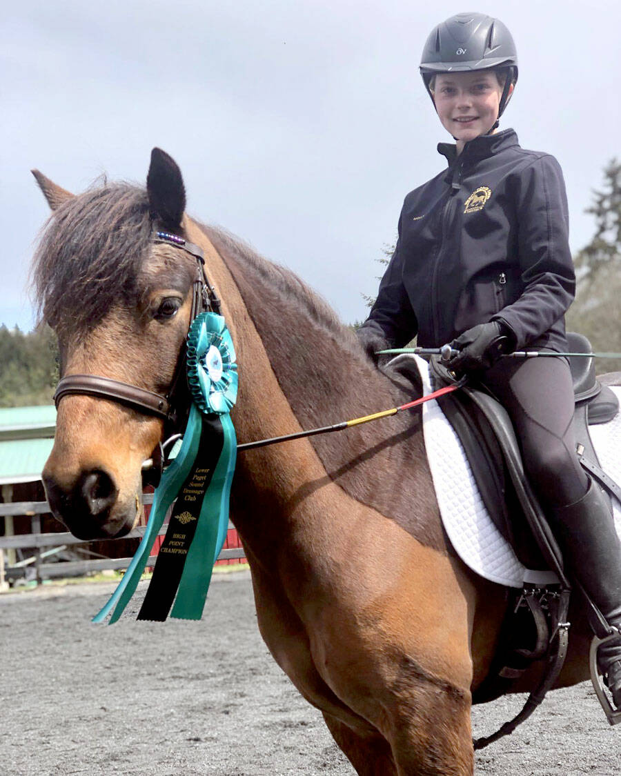 Heron Pond Farm student Molly Lance, aboard Rocky, with her Lower Puget Sound Dressage High Point Series winning ribbon in the Champion Junior Division. (Courtesy photo)