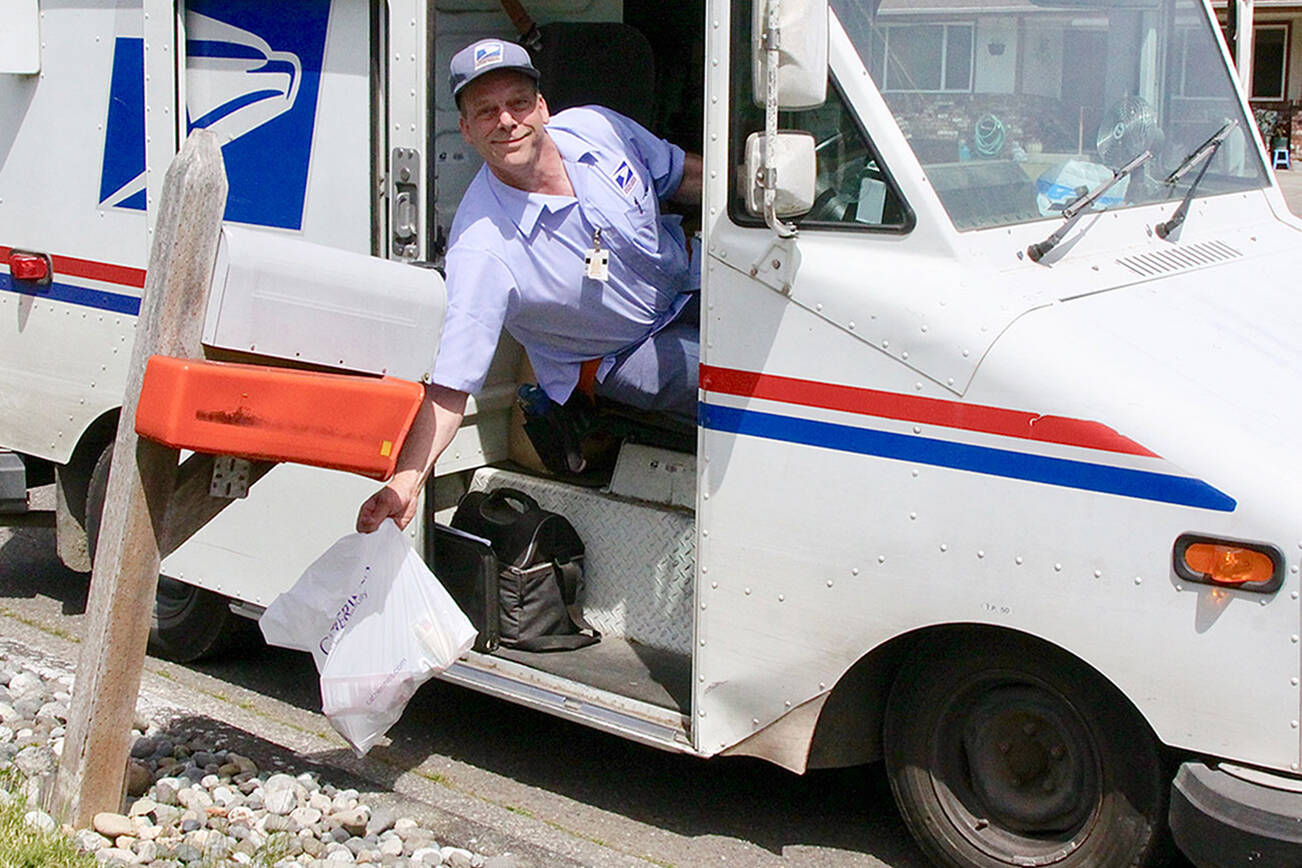 Alex Baker of the USPS picks up some food donations on his west Port Angeles route several years ago.