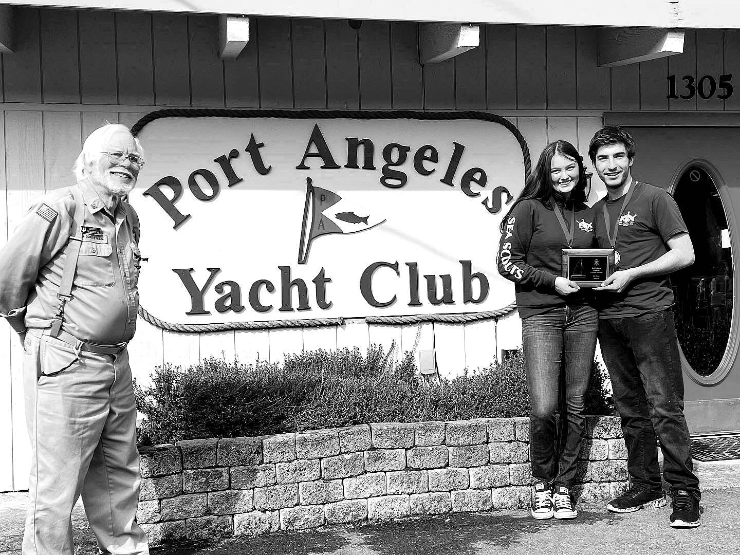 Submitted photo 
Sailors Ella Schultz, middle, and Ozzy Minard earned a first-place finish in the first Kelly Cup Regatta hosted by the Sea Scout Ship Marvin Shields and the Port Angeles Yacht Club, represented by Doug Mecham.