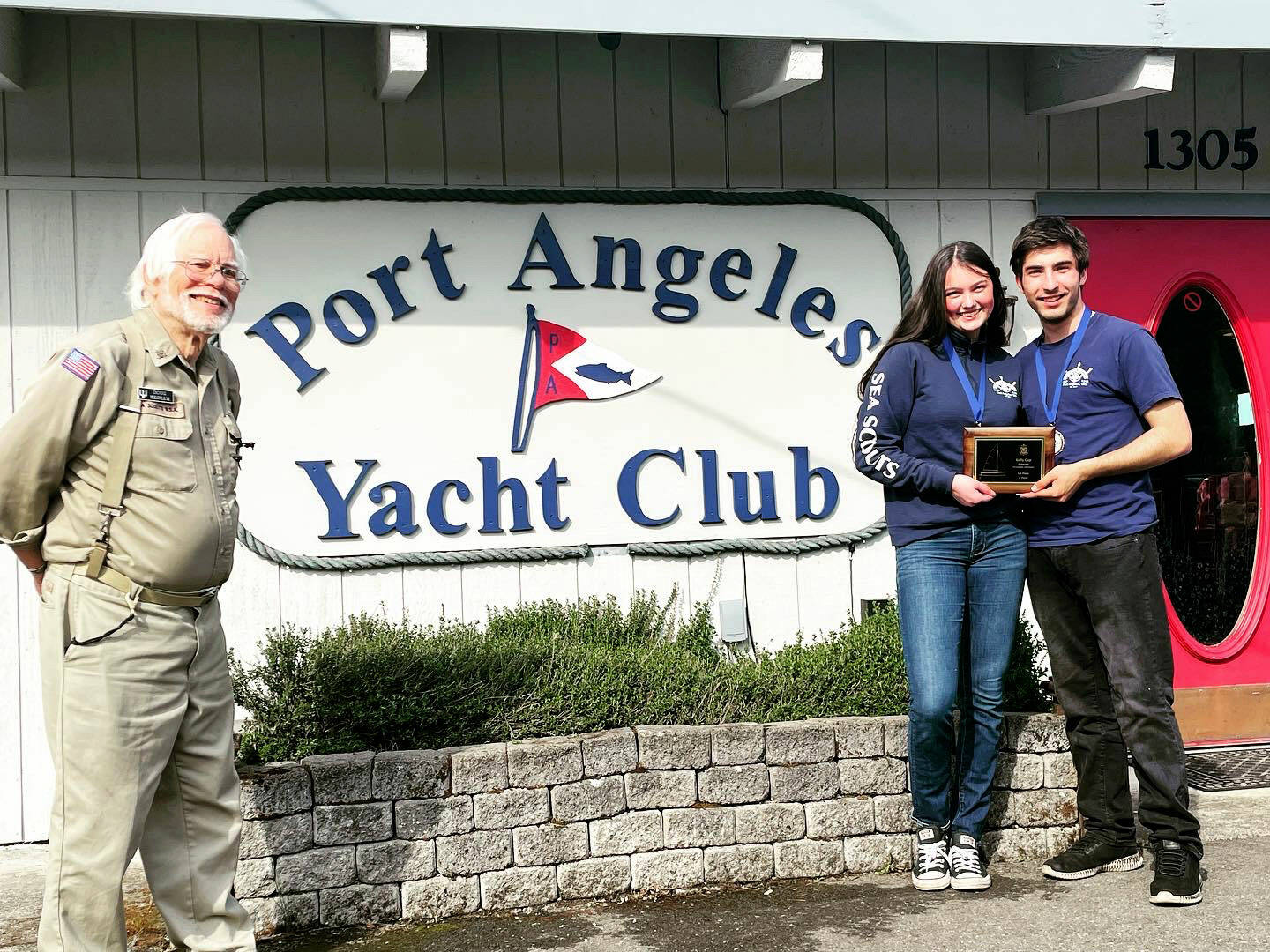 Sailors Ella Schultz, middle, and Ozzy Minard earned a first-place finish in the first Kelly Cup Regatta hosted by the Sea Scout Ship Marvin Shields and the Port Angeles Yacht Club (represented by Doug Mecham).