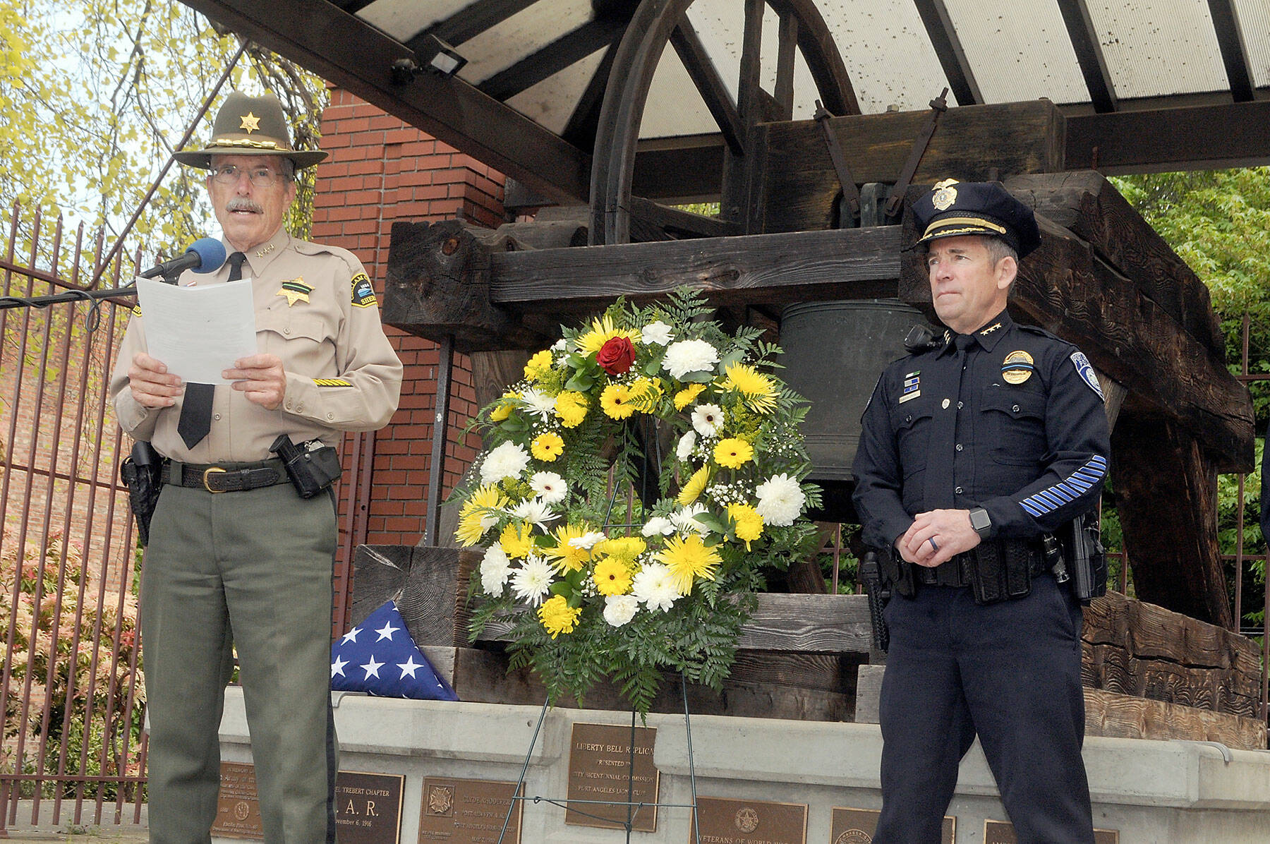 Clallam County Sheriff Bill Benedict, left, reads off the names of Washington law enforcment officers killed in the line of duty as Port Angeles Police Chief Brian Smith looks on during a ceremony of Friday honoring law enforcement personnel as part of National Police Week. (Keith Thorpe/Peninsula Daily News)