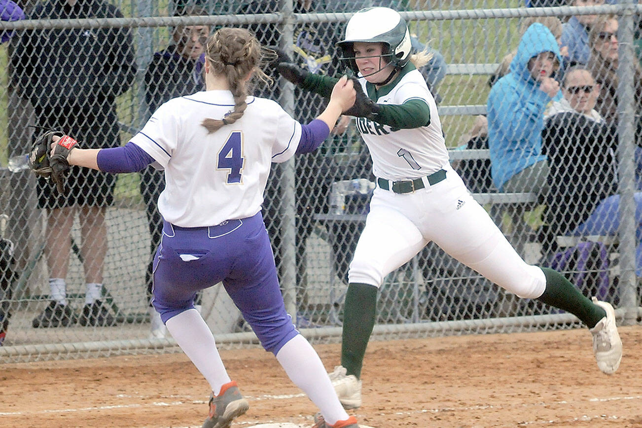 Keith Thorpe/Peninsula Daily News
Sequim second baseman Addie Smith just avoids into a collision with Port Angeles baserunner Heidi Leitz at first base during Friday's game at Dry Creek in Port Angeles.