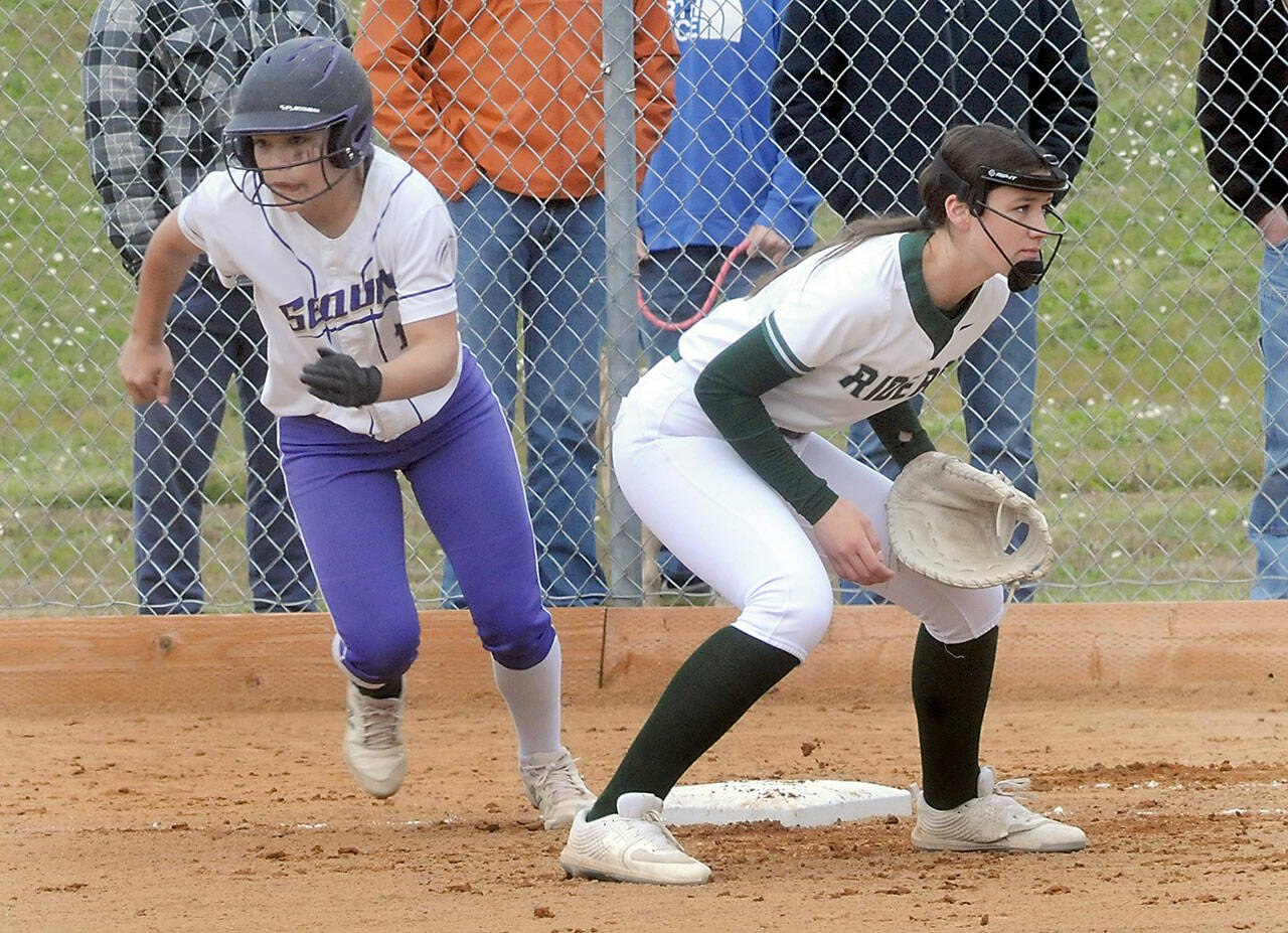 Sequim’s Tayli Rome takes off for second as Port Angeles first baseman Lexie Smith watches the delivery on Friday in Port Angeles. (Keith Thorpe/Peninsula Daily News)