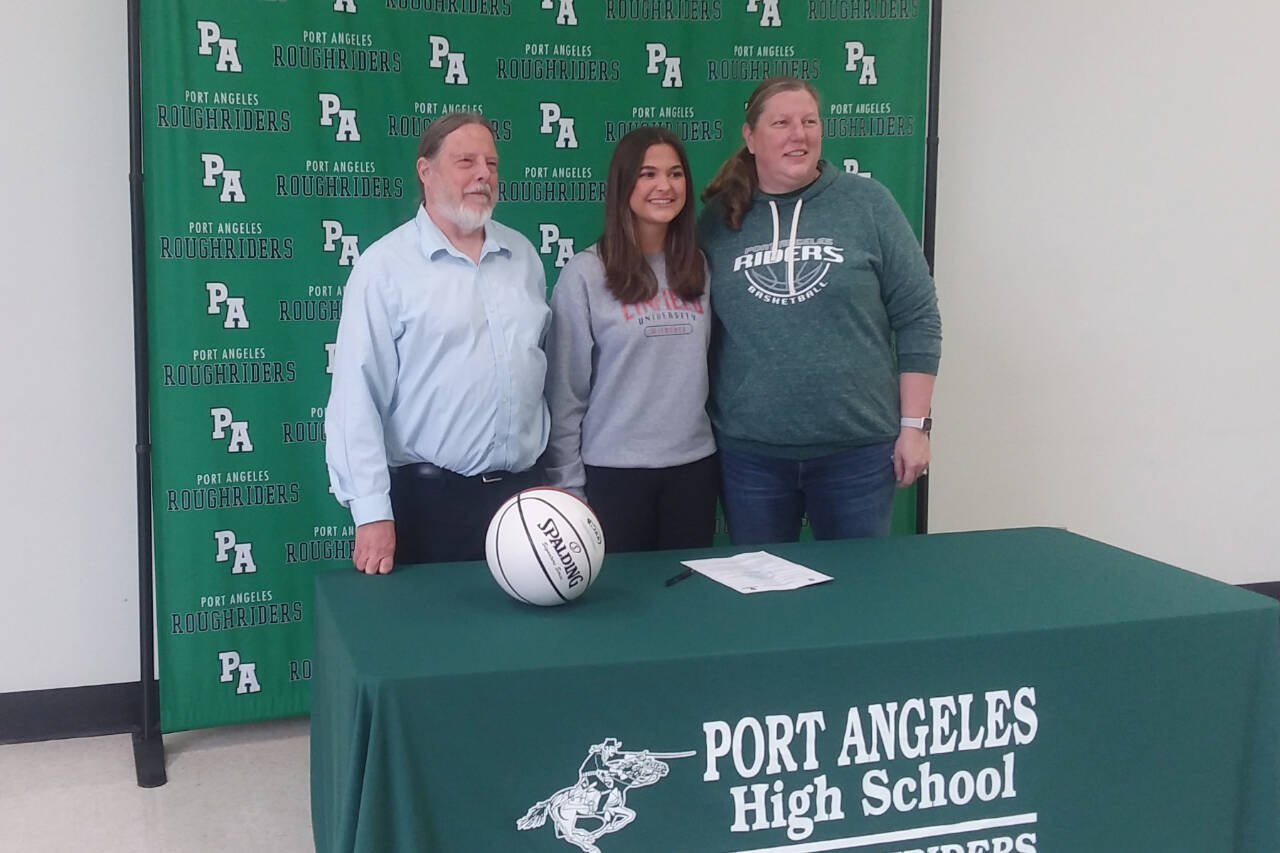 From left, Port Angeles head girls basketball coach Michael Poindexter, Eve Burke and assistant coach Jennifer Rogers at Burke's signing to play for Linfield College in McMinnville, Ore. (Pierre LaBossiere/Peninsula Daily News)