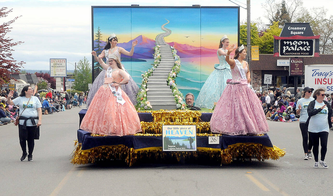With the theme of “Sequim, Our Little Piece of Heaven,” the Sequim Irrigation Festival float featuring royalty, clockwise from upper left, Queen Isabella Williams and princesses Katherine Gould, Ellie Turner and Lauren Willis, rolls through downtown Sequim on Saturday. The parade featured more than 90 entries with its return to being an in-person event. Driving the float was Guy Horton. (Keith Thorpe/Peninsula Daily News)