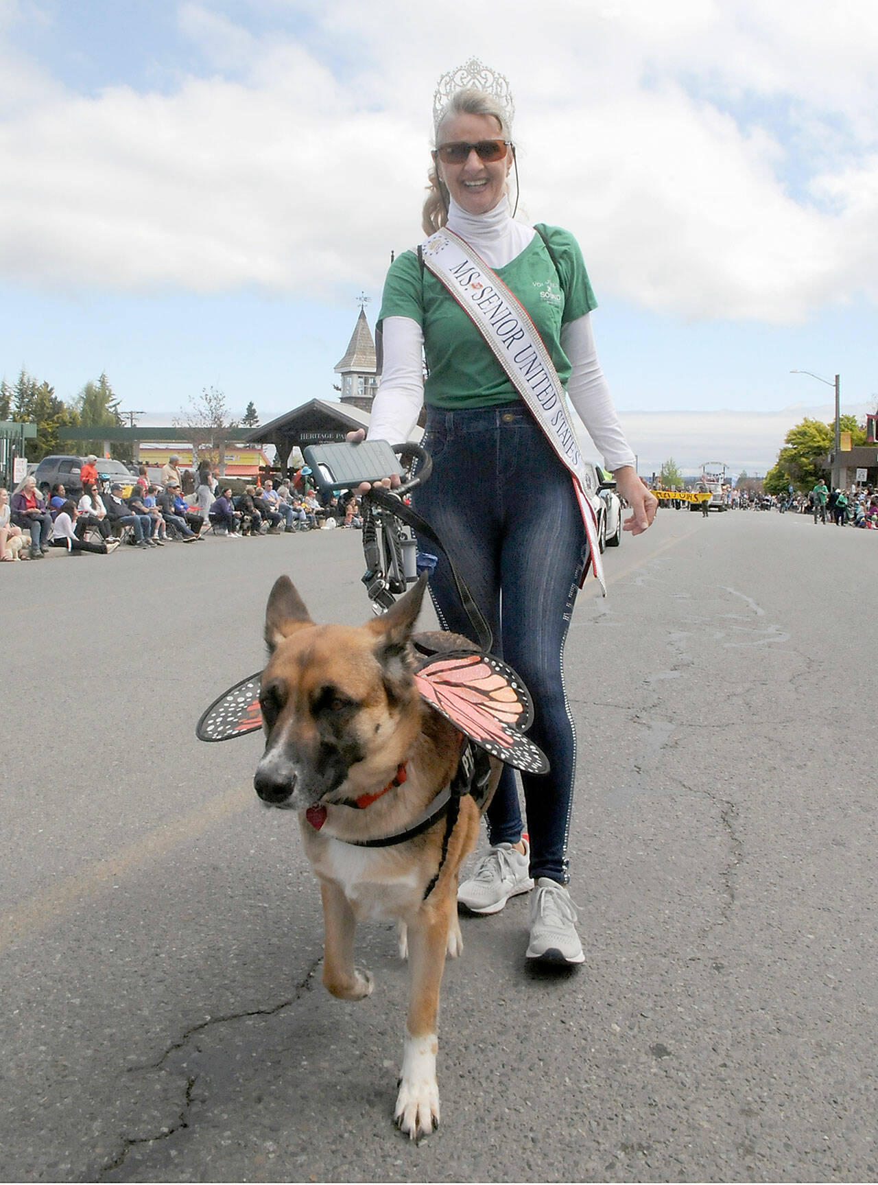 Captain-Crystal Stout of Sequim, Ms. Senior United States 2020, and her dog, Lucee-Light, march in Saturday’s parade. (Keith Thorpe/Peninsula Daily News)