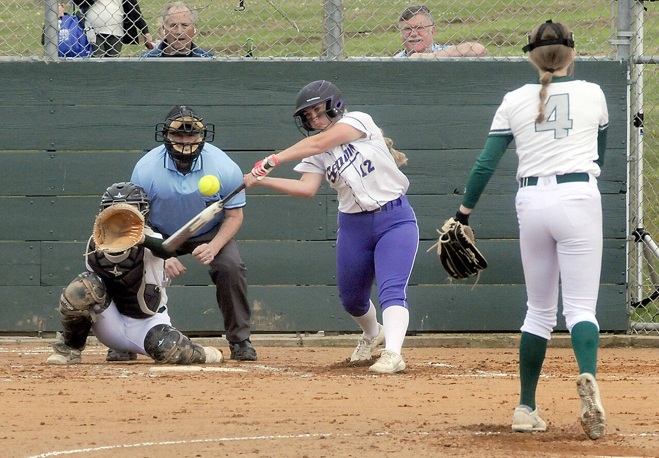 Sequim’s Michaela Green swings at a pitch from Port Angeles’ Teagan Clark as catcher Zoe Smithson waits for the delivery on Friday in Port Angeles. Both teams will be playing at the Bi-district tournament and both teams start off one win away from qualifying for state. (Keith Thorpe/Peninsula Daily News)