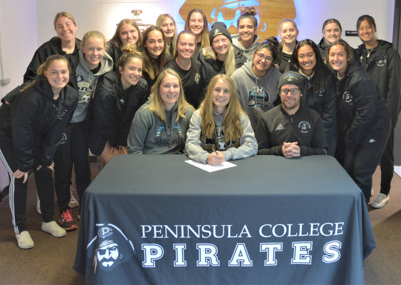 Peninsula College
Sequim's Hannah Wagner signs to play college for the Peninsula College Pirates and poses with her teammates and coach Kanyon Anderson.