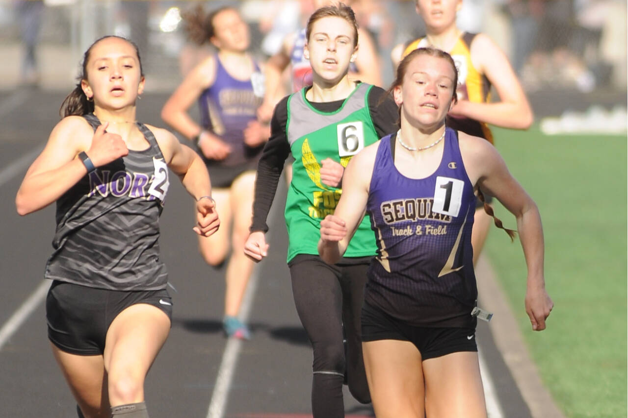 Sequim's Riley Pyeatt (1) won the 400, 800, 1,600 and anchored the Wolves' 4x400 girls relay team that took first at the 2A West-Central District 3 track and field meet in Belfair. (Michel Dashiell/Olympic Peninsula News Group)
