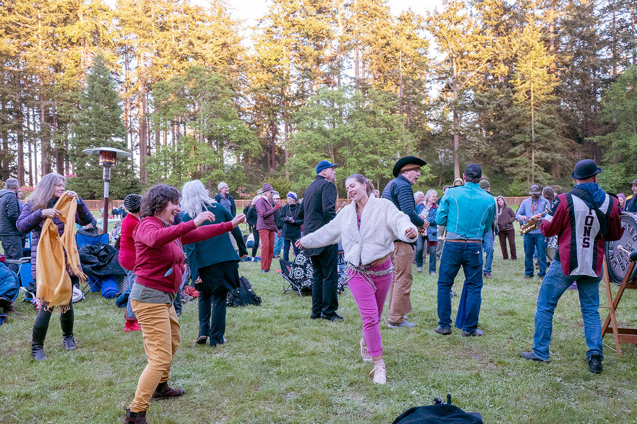 Port Townsend business owner Connie Segal dances with a friend to the brassy notes of the Unexpected Brass Band during the start of Chautauqua Week on Littlefield Green at Fort Worden State Park on Friday. (Steve Mullensky/for Peninsula Daily News)
