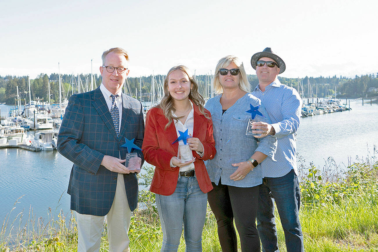 Holding their Leadership trophies presented to them in an awards program Saturday at the Port Ludlow Marina are, from left, Rob Birman, executive director of Centrum, Business Leader of the Year; Akira Anderson, Future Business Leader of the Year; and Wendy and Brent Davis, owners of Lila’s Kitchen, Rising Entrepreneur of the year. Two other winners who were unable to attend are Ariel Speser, Citizen of the Year, and Dr. Allison Berry, Young Professional of the Year. (Steve Mullensky/for Peninsula Daily News)