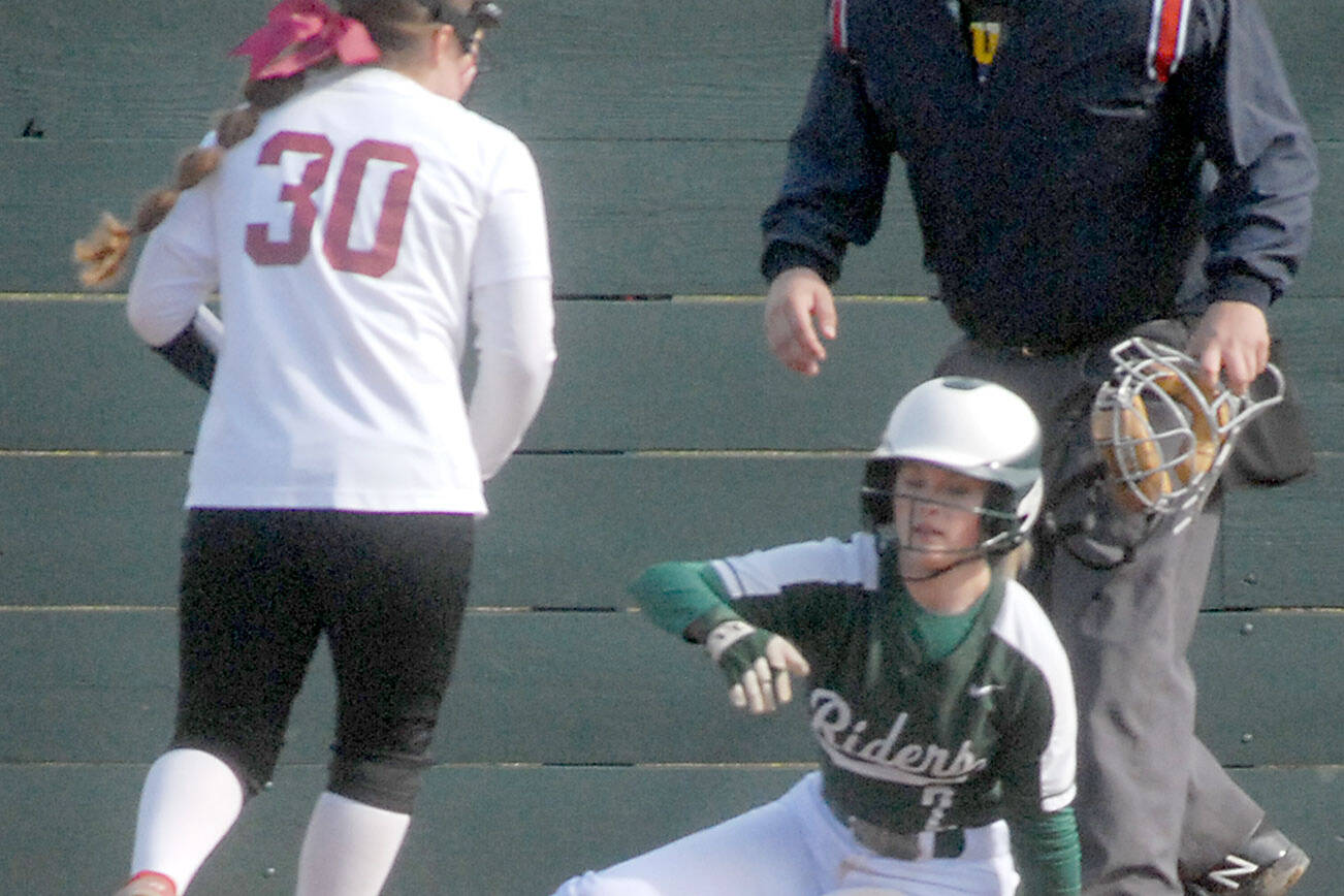 Keith Thorpe/Peninsula Daily News
Port Angeles baserunner Peyton Rudd looks towards Kingston pitcher Jayla Moon while stealing home after a wild pitch got away from the catcher during a game earlier this season.