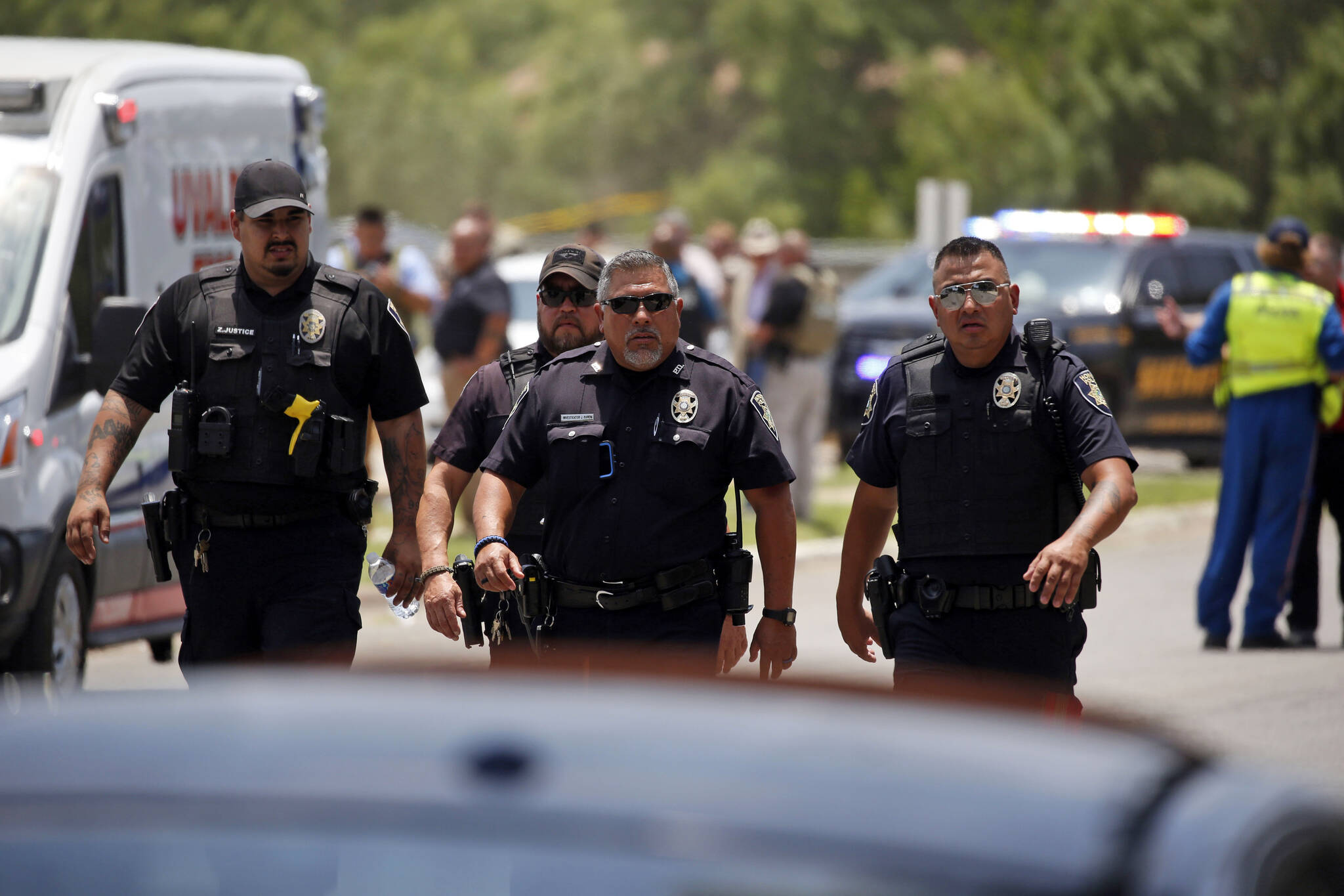 Police walk near Robb Elementary School following a shooting, Tuesday in Uvalde, Texas. (AP Photo/Dario Lopez-Mills)
