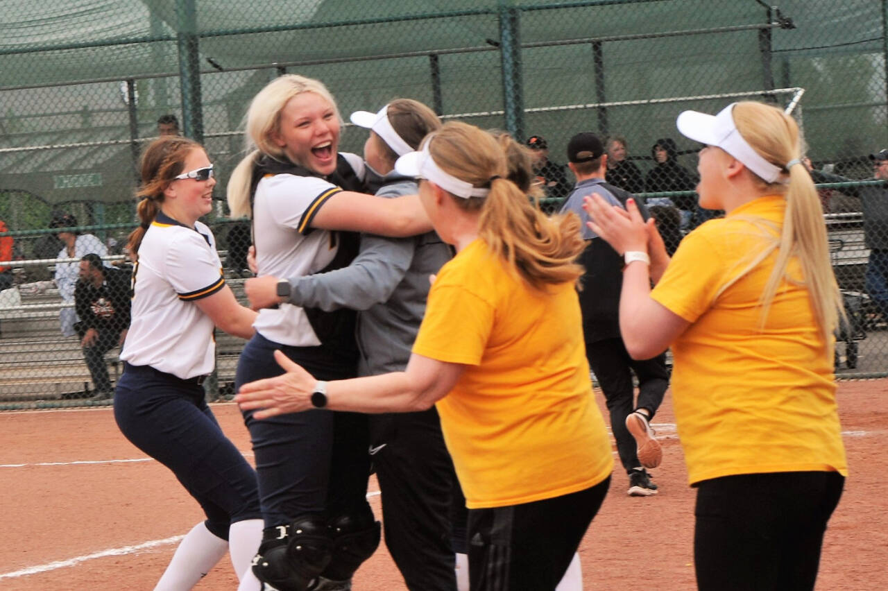 Forks players celebrate beating Rainier to come in third place at the state 2B tournament in Yakima. (Lonnie Archibald/for Peninsula Daily News)