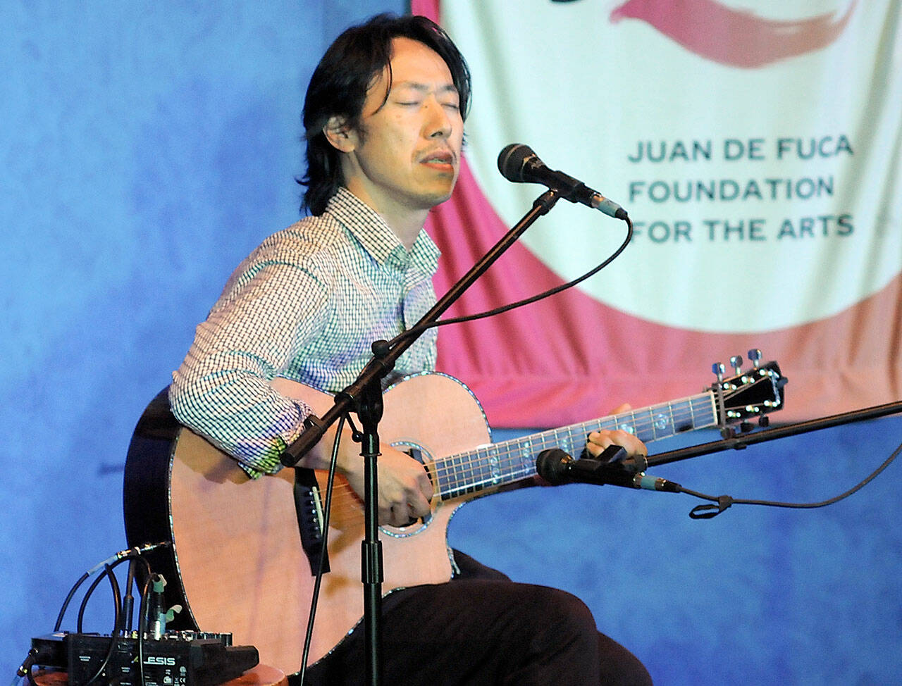 Hiroya Tsukamoto, originally from Kyoto, Kyoto Prefecture, Japan, but now living in the United States, performs on classical guitar on Saturday in Port Angeles. (Keith Thorpe/Peninsula Daily News)