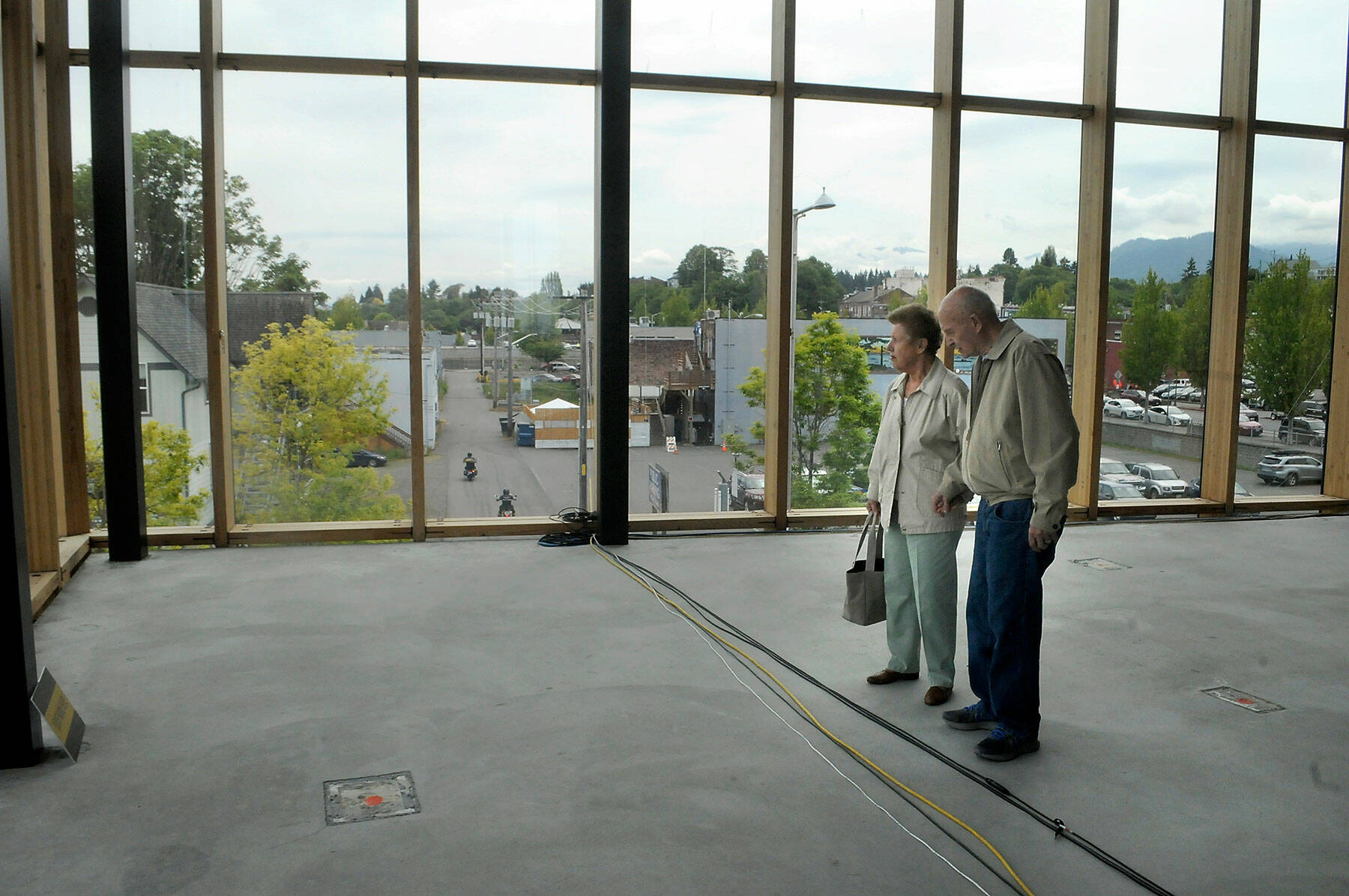Jan and Ray Morgan of Port Angeles admire the view from the glass-walled conference center during an open house at the Field Hall Arts & Events Hall on Thursday in Port Angeles. (Keith Thorpe/Peninsula Daily News)