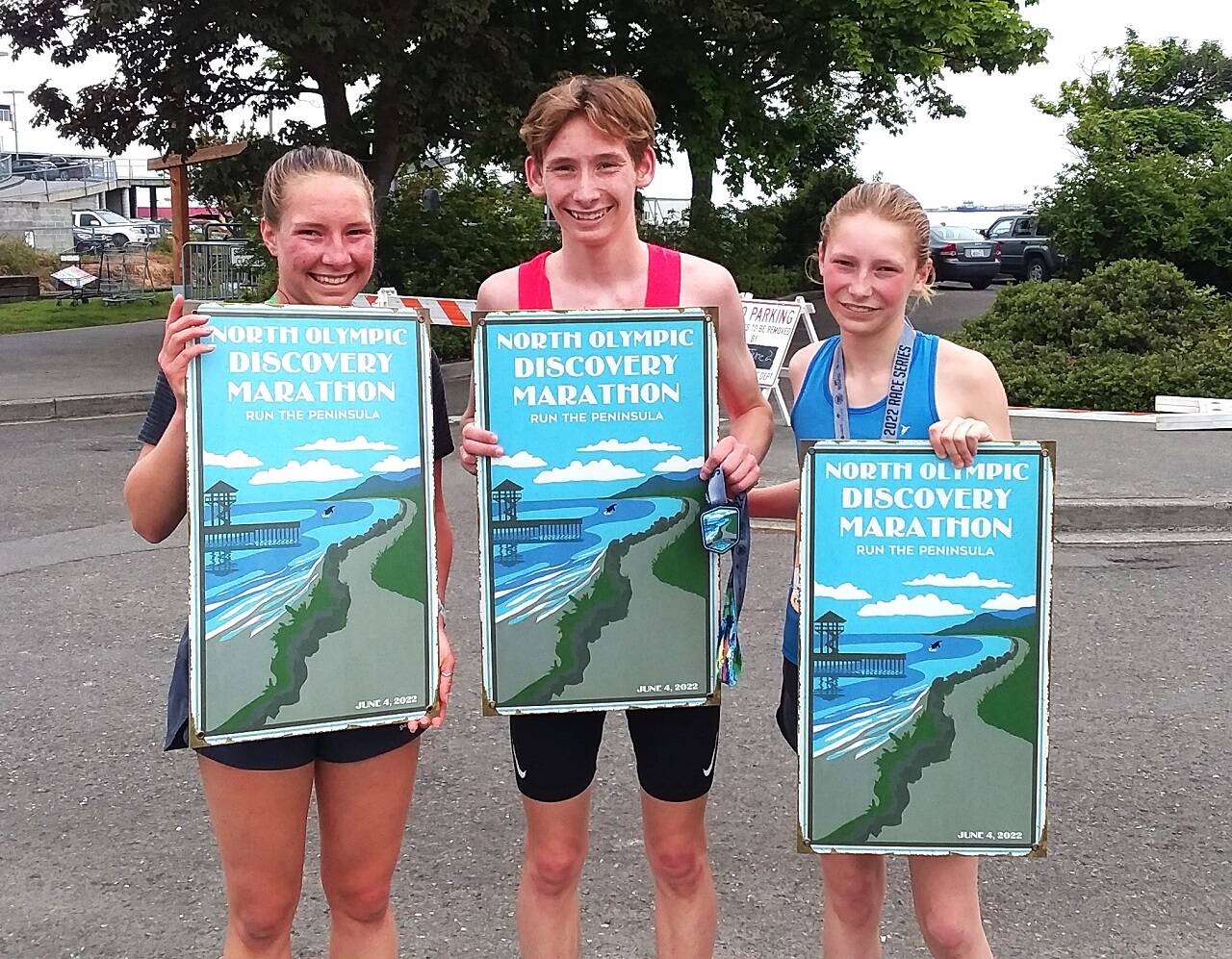 Lauren Larson, Langdon Larson and Leia Larson celebrate their victories at the North Olympic Discovery Marathon. Lauren won the women's 10K, Langdon the men's 10K and Leia the women's 5K. (Pierre LaBossiere/Peninsula Daily News)