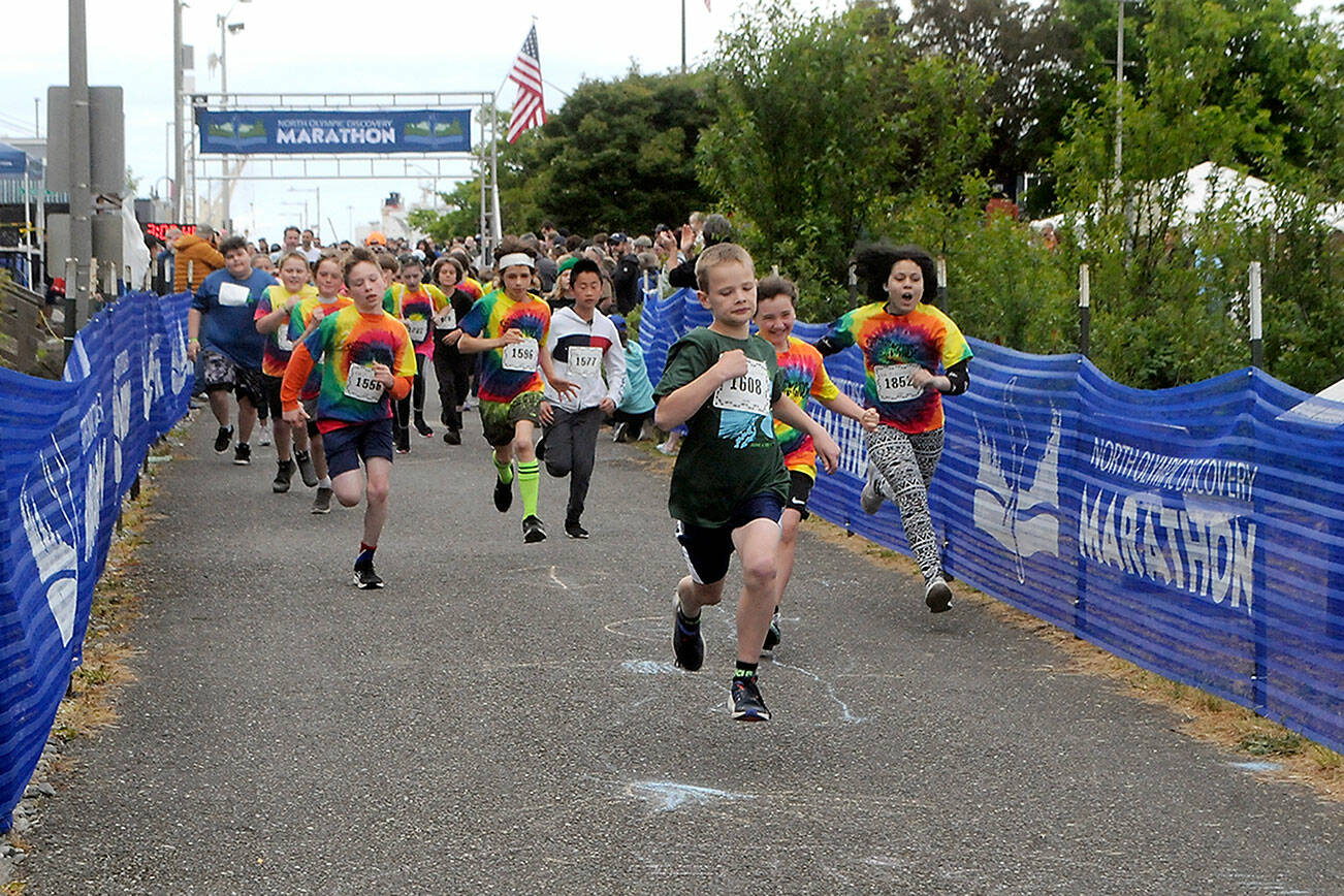Youths take off from the starting line of Saturday’s Kids’ Marathon, a family-friendly feature of the Olympic Discovery Marathon, along the Waterfront Trail at Port Angeles City Pier. About 300 children were expected to take part in the 1.2-mile fun run. (Keith Thorpe/Peninsula Daily News)