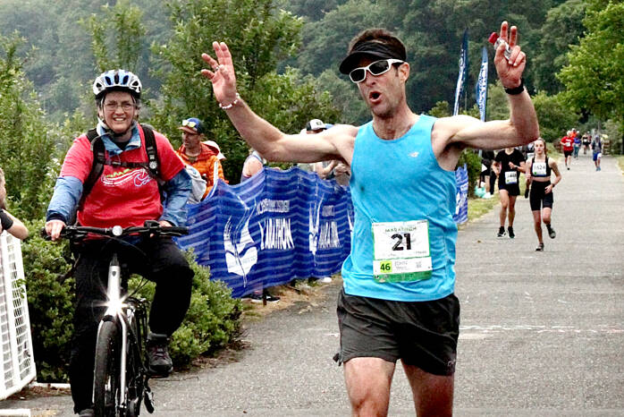 John Mauro of Port Townsend crosses the line as the men’s winner Sunday in the North Olympic Discovery Marathon in Port Angeles. (Dave Logan/for Peninsula Daily News)
