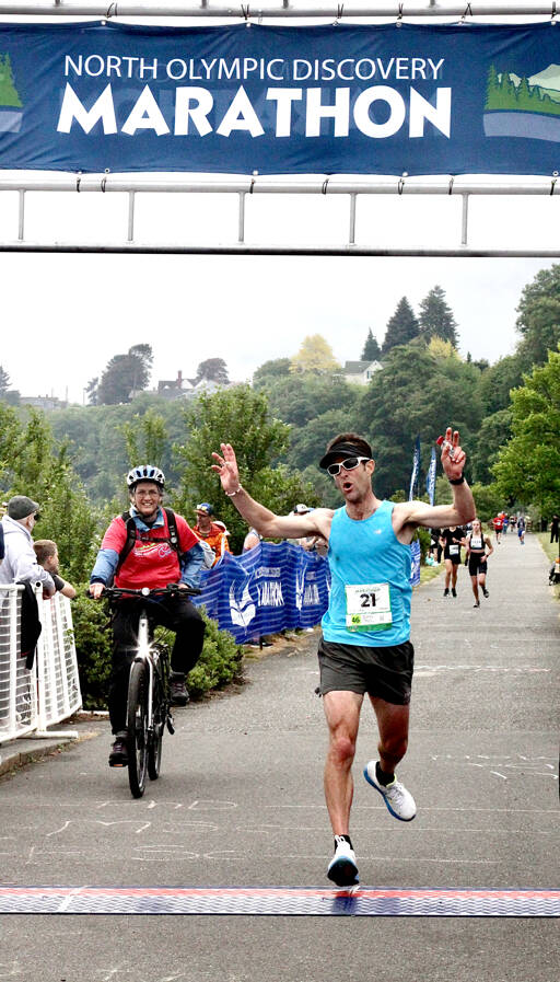 John Mauro of Port Townsend crosses the line as the men’s winner Sunday in the North Olympic Discovery Marathon in Port Angeles. (Dave Logan/for Peninsula Daily News)
