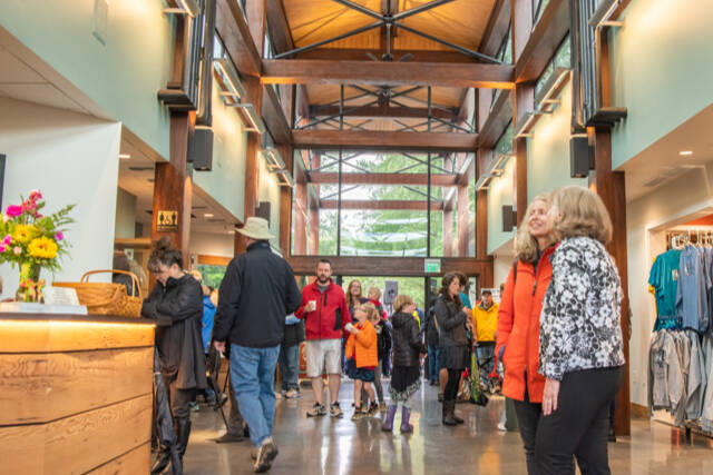 Community members and dignitaries explore the newly refurbished and expanded Dungeness River Nature Center. (Emily Matthiessen/Olympic Peninsula News Group)