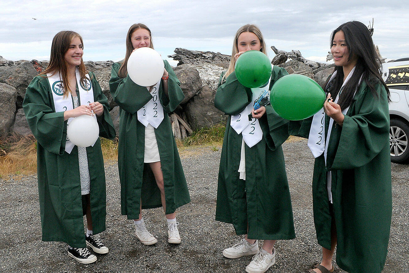 Keith Thorpe/Pennsula Daily News
Port Angeles High School graduates, from left, Hannah Basden, Zoe Smithson, Peyton Rudd and Jenna McGoiff inflate balloons that will adorn a car taking part in Friday's graduation parade through the streets of Port Angeles from Ediz Hook to the high school. The parade, which was developed to honor graduates after COVID-19 forced the cancellation of commencement in 2020, was kept as a prelude to the conventional ceremony at Port Angeles Civic Field.