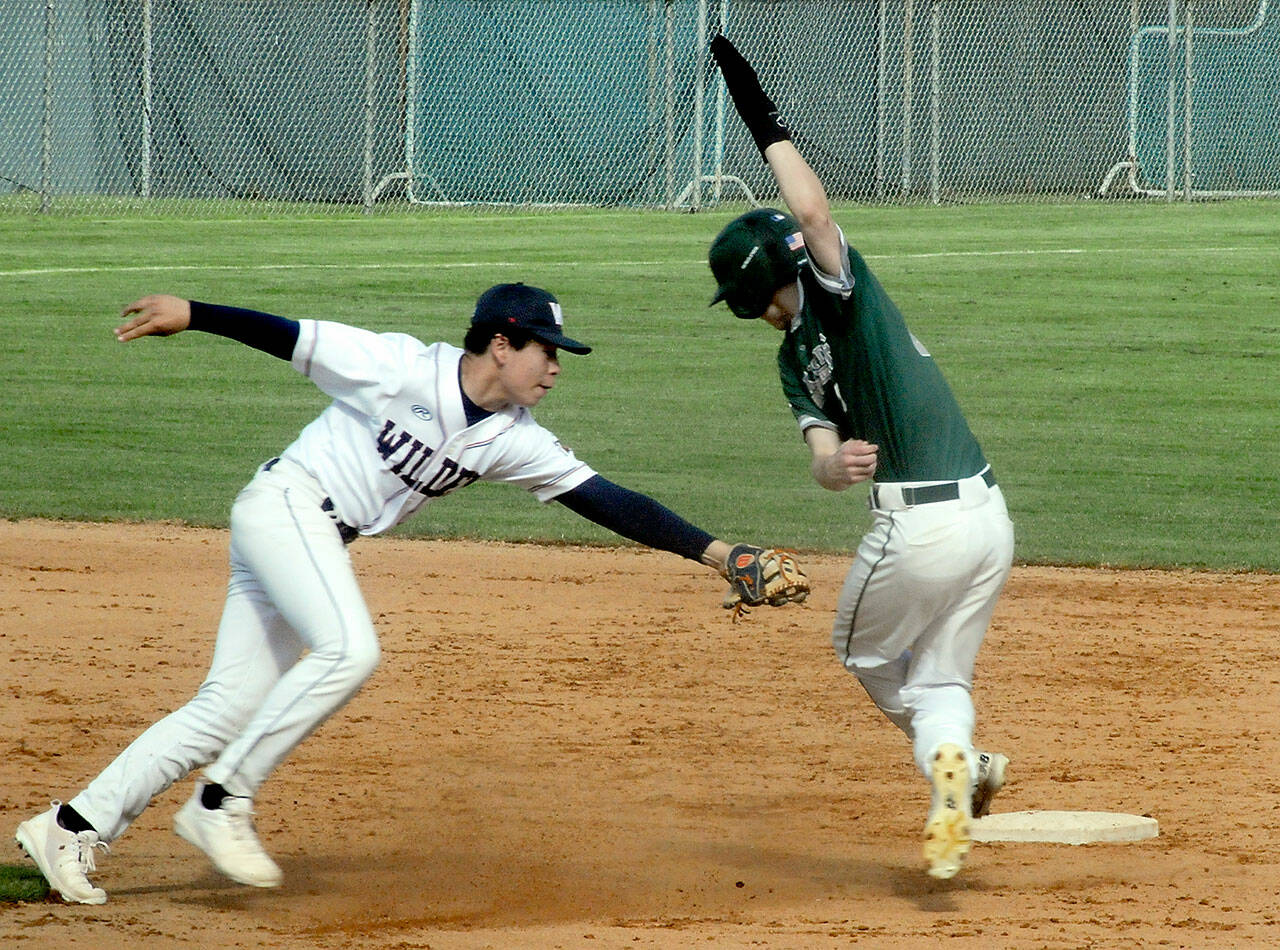 Wilder second baseman Payton Cagey, left, tags out Lakeside Recovery baserunner Luke Reynolds, who was caught in a rundown between first and second on Saturday at Port Angeles Civic Field. (Keith Thorpe/Peninsula Daily News)