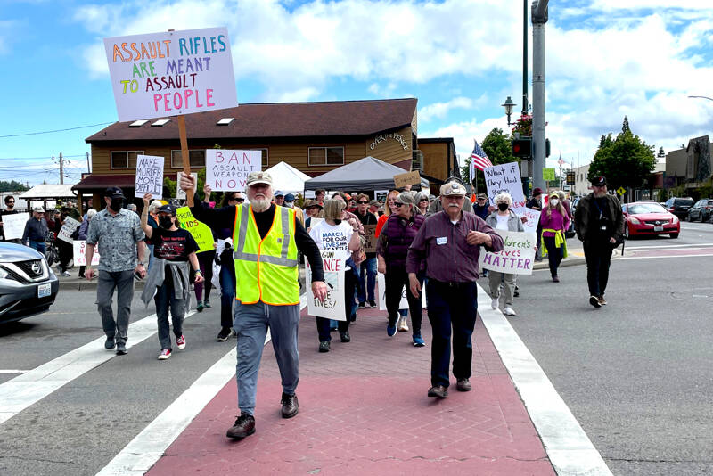 Demonstrators in Sequim demand an end to gun violence and call for lawmakers to take action on stricter firearm laws as part of the nationwide March for Our Lives protests Saturday. (Paula Hunt/Peninsula Daily News)