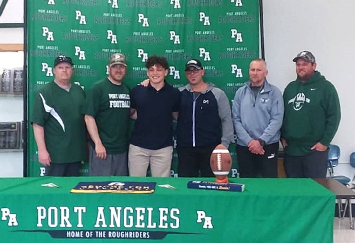 Port Angeles football player Daniel Cable signed to play with George Fox University in Newberg, Ore., on Monday. His Roughrider coaches all attended the ceremony. (Pierre LaBossiere/Peninsula Daily News)
Port Angeles football player Daniel Cable signed to play with George Fox University in Newberg, Ore., on Monday. His Roughrider coaches all attended the ceremony. (Pierre LaBossiere/Peninsula Daily News)