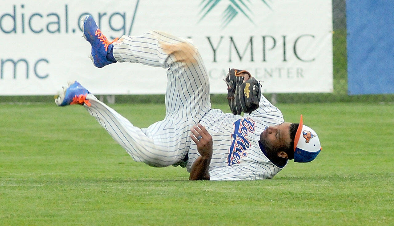 Lefties’ center fielder Golden Tate rolls on the ground after making a diving catch in the top of the third to end Bend’s half of the inning on Tuesday in Port Angeles. (Keith Thorpe/Peninsula Daily News)