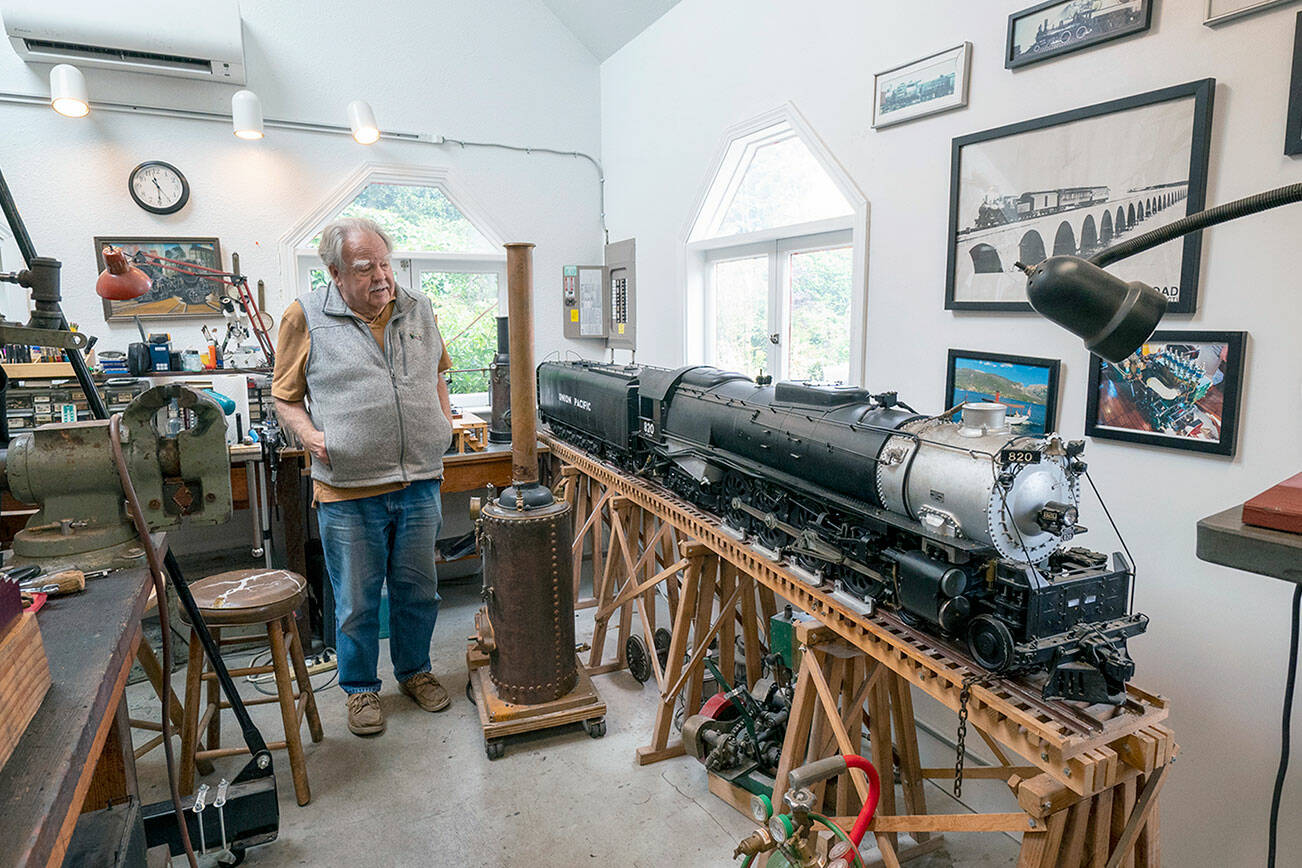 Jim Kunc, a Port Townsend resident and a retired North West Airlines pilot, proudly shows off the 1-inch scale model of a 1930s Union Pacific Northern train he built in his home shop. A lifelong train hobbyist, this model took 20 years to make. (Steve Mullensky/for Peninsula Daily News)