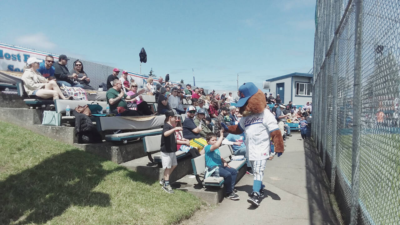 Port Angeles Lefties mascot Timber high-fives young fans at Sunday’s game at Civic Field. (Pierre LaBossiere/Peninsula Daily News)