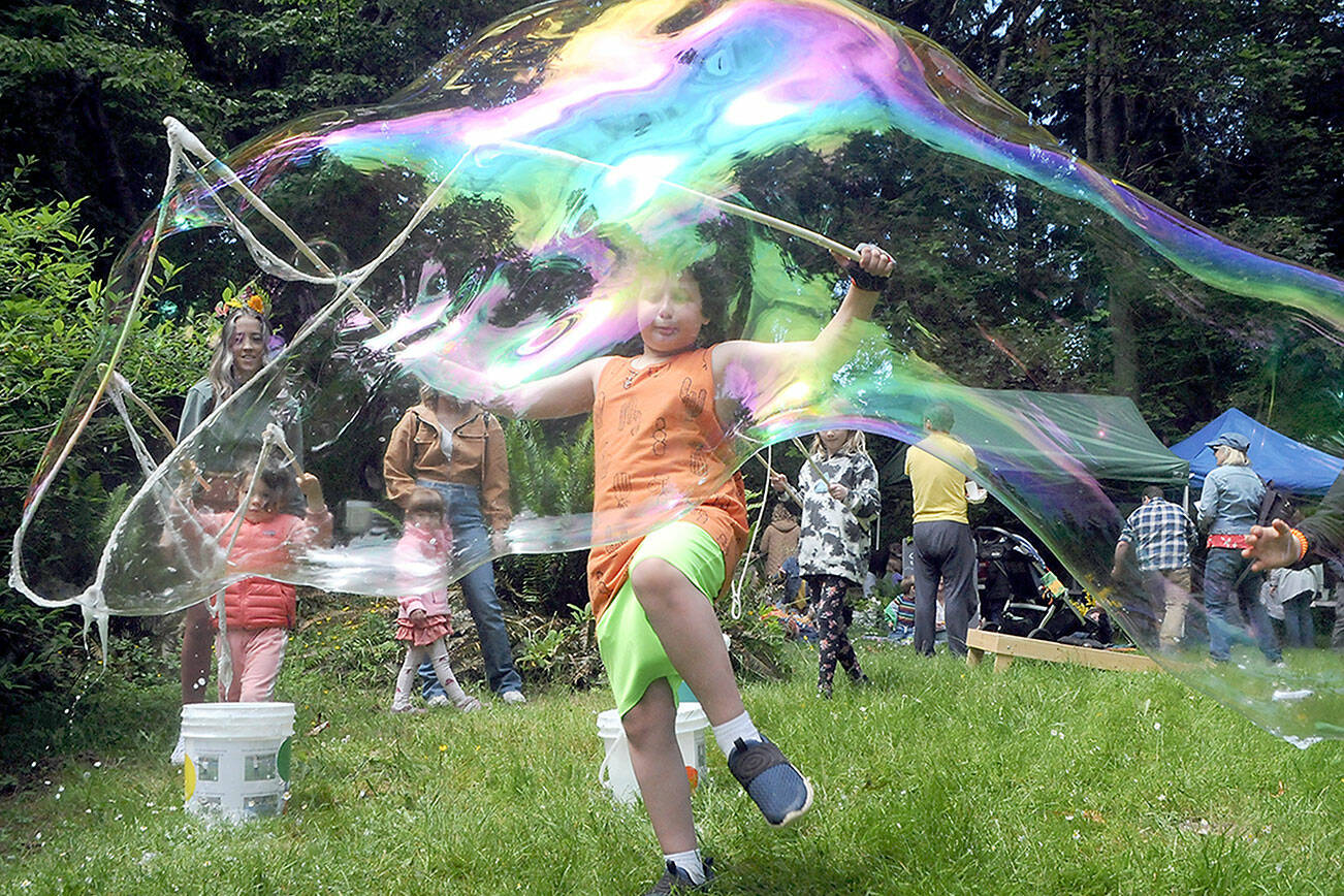 Emmett Stratford, 8, of Port Angeles creates a gigantic soap bubble as one of the children’s activities at Summertide Solstice Festival on Saturday at the Port Angeles Fine Arts Center. (Keith Thorpe/Peninsula Daily News)