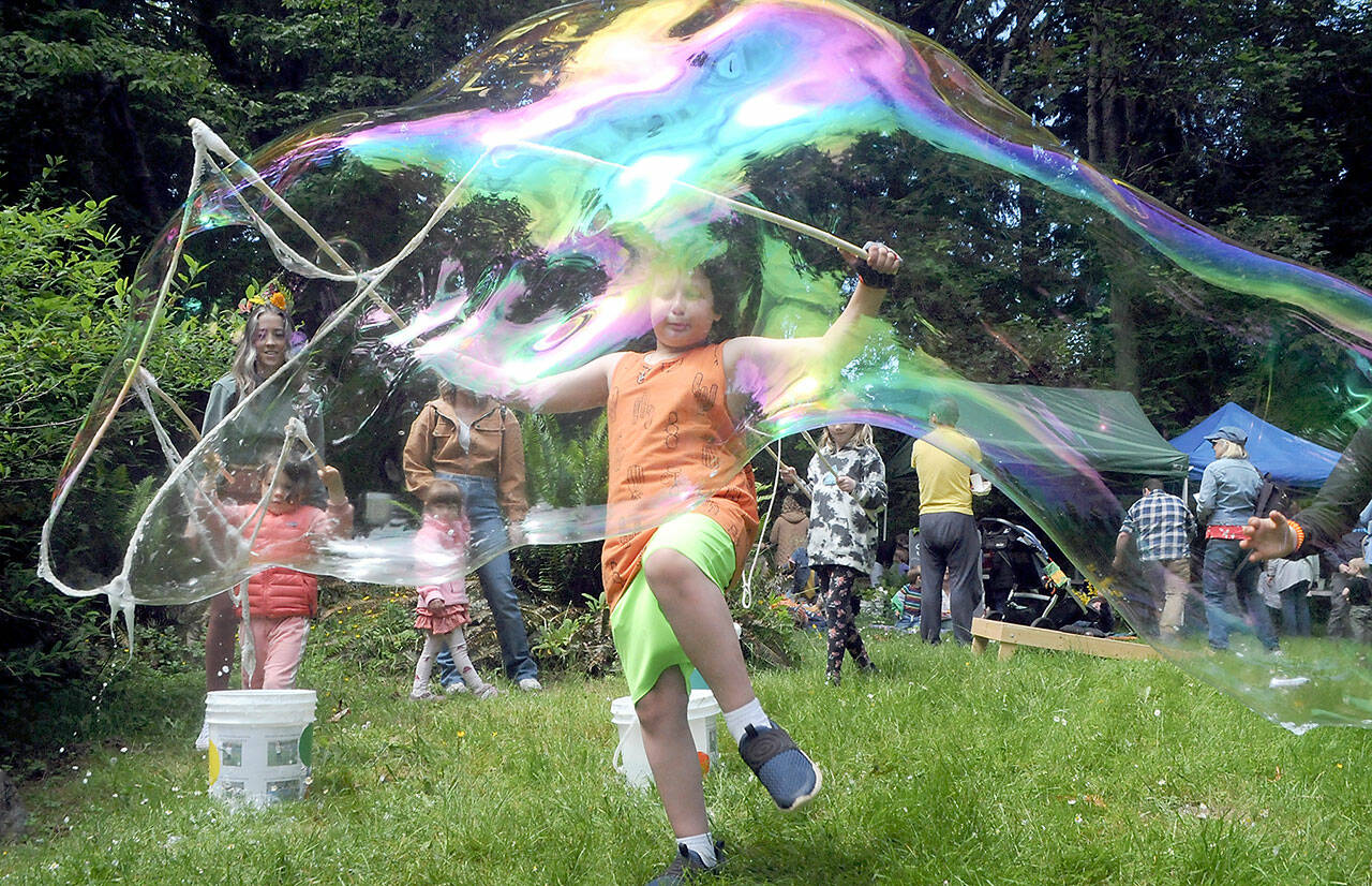 Emmett Stratford, 8, of Port Angeles creates a gigantic soap bubble as one of the children’s activities at Summertide Solstice Festival on Saturday at the Port Angeles Fine Arts Center. (Keith Thorpe/Peninsula Daily News)